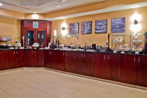 a restaurant with a counter in a room at SpringHill Suites by Marriott Charlotte Airport in Charlotte