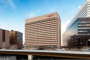 a building with a sign on the side of it at Courtyard by Marriott Shin-Osaka Station in Osaka