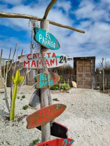 a pole with street signs on it in the desert at Hogar mágico en Punta de Choros in Choros