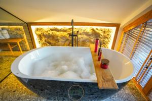 a bath tub with bubbles in it in a bathroom at Holiday Villas in Orllan