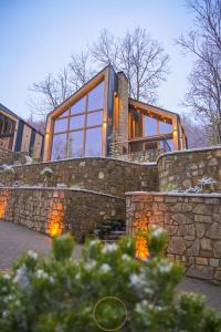 a home with a stone retaining wall and a stone fence at Holiday Villas in Orllan