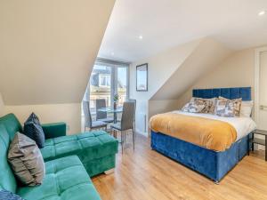 een slaapkamer met een bed en een bank bij Apartment Five - Uk44289 in Arbroath
