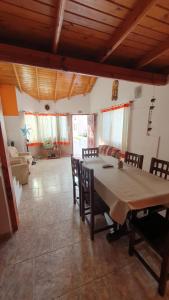 a dining room with a table and chairs and a living room at La Mar in Mar de Ajó