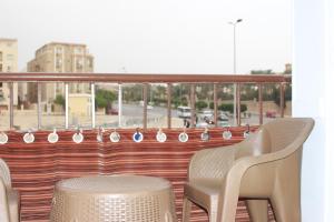 a pair of chairs and a table on a balcony at Entire rental unit in New Cairo, Egypt in Cairo