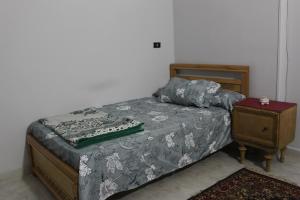 a bedroom with a bed and a night stand at Entire rental unit in New Cairo, Egypt in Cairo