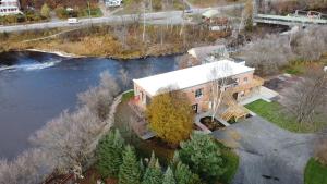 an aerial view of a house next to a river at Burk's Fall Modern Mill House Apt 3 in Burks Falls