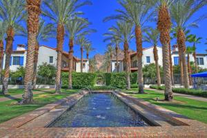 a pool in the middle of a yard with palm trees at LV028 Private Downstairs Studio on Main Paseo in La Quinta