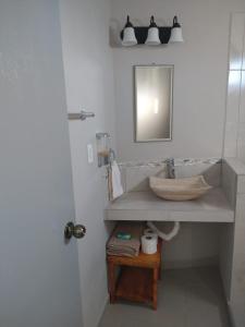 a bathroom with a sink and a mirror at Hotel Vista Mag-Bay in San Carlos