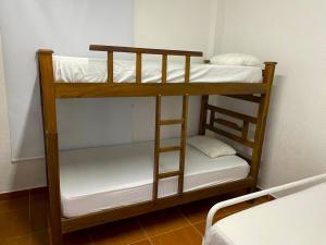 a couple of bunk beds in a room at Hostal Casablanca Santa Marta in Santa Marta +18 photos