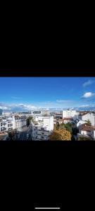 a view of a city with buildings and a blue sky at Cosy little nest next to Paris in Issy-les-Moulineaux