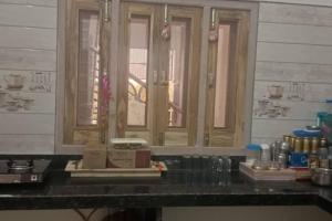 a kitchen counter with a window and a counter top at Salasar Sadan in Bikaner