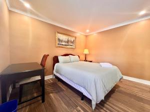 a bedroom with a bed and a desk next to a bed at Newly Renovated Home in Toronto Near Subway in Toronto