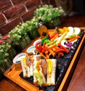 a plate of food with a sandwich and french fries at Kenting 157 Boutique Hotel in Kenting