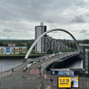 a bridge over a river with cars on it at SECC Ovo Apartments in Glasgow