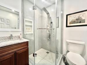 a bathroom with a shower and a toilet at Newly Renovated Home in Toronto Near Subway in Toronto