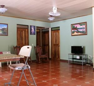 sala de estar con mesa, sillas y TV en Quinta Alfa, en Jesús María