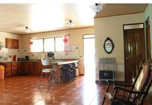 a kitchen with chairs and a table in a room at Quinta Alfa in Jesús María