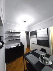 uma sala de jantar com uma mesa e uma prateleira com copos de vinho em Magnífico apartamento no Rio de Janeiro