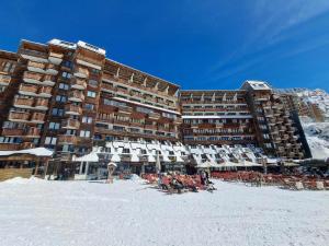 um grupo de pessoas sentadas na praia em frente a um hotel em Appartement Avoriaz, 2 pièces, 5 personnes - FR-1-314-257 em Morzine