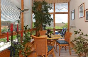 a dining room with a table and chairs at Ferienwohnungen Krenn in Tittling