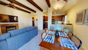 a living room with a blue couch and a table at LV217 Superb 2 Bedroom Overlooking the Lap Pool in La Quinta