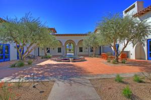 a courtyard with trees in front of a building at LV217 Superb 2 Bedroom Overlooking the Lap Pool in La Quinta