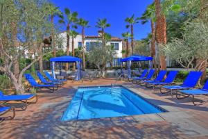 a swimming pool with blue chairs and a swimming poolvisorvisor at LV217 Superb 2 Bedroom Overlooking the Lap Pool in La Quinta