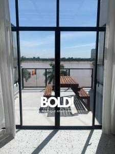 a view from a window of a balcony with a picnic table at BOLD! apartment @ Riverside in Phnom Penh