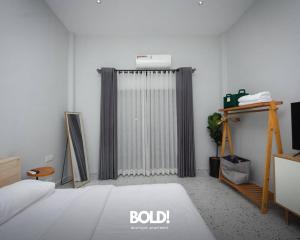 a bedroom with a bed and a radiator at BOLD! apartment @ Riverside in Phnom Penh