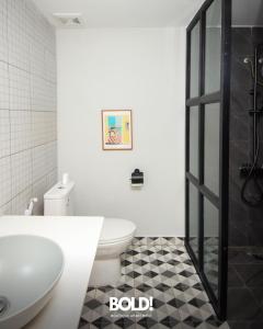 a bathroom with a toilet and a glass shower at BOLD! apartment @ Riverside in Phnom Penh