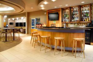 a bar in a restaurant with stools and a tv at SpringHill Suites by Marriott Chicago Waukegan/Gurnee in Waukegan