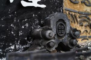 a black fire hydrant sitting on the side of a building at Kuranoyado Matsuya in Fujikawaguchiko