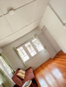 an empty room with a couch and a window at OTOUSAN HOUSE in Bukittinggi