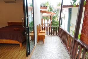 a bedroom with a bed on a balcony at The Scenery Beach Resort in Baan Khai