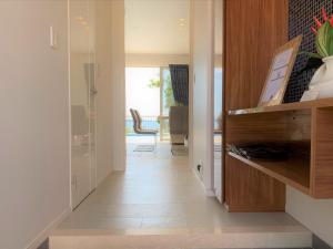 a hallway of a home with a wooden cabinet at -Villa Rikyu- 離宮 in Miyako Island