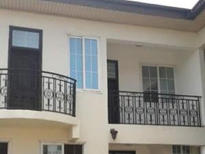 a white building with black balconies and windows at WILLS COURT in Accra