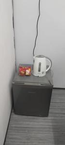a coffee maker and a cup on top of a cpu at Inap Desa Hajah Yani, Kg Olak Lempit in Banting