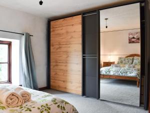 a bedroom with a large sliding closet door at The Granary in Woolaston