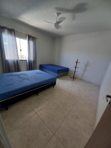 En eller flere senge i et værelse på Casa Azul em Jaconé