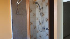 a shower with a shower head in a bathroom at Private room with shared facilities W in Werribee