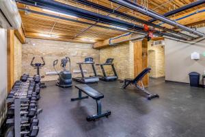 a gym with several treadmills and exercise bikes at FREE PARKING 5 Star Quiet 2 BR Loft - Central - FULLY Stocked in Winnipeg