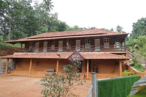 a building with a sign in front of it at Wild Mist Homestay in Rānī