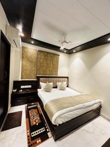 a bedroom with a large bed and a table at KASHI DARSHAN in Varanasi