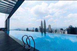 a swimming pool with a view of a city at The Platinum Suites KLCC in Kuala Lumpur