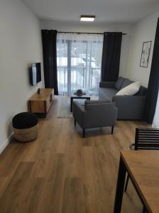 sala de estar con sofá y mesa en Apartament 9 SzklarSki en Szklarska Poręba