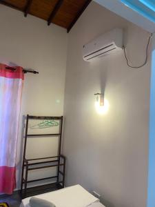 a room with a white wall with a light and a ladder at Mirissa Gold Rush Villa in Mirissa