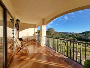 an indoor balcony with a view of the mountains at Casa Migjorn in Valls de Torroella