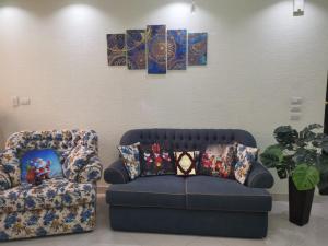 a living room with a couch and a chair at 2 bedroom, 4 beds, apartment in El sheikh Zayed Cairo Egypt in Sheikh Zayed