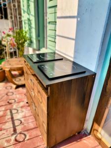 a wooden cabinet with a counter top on a patio at The Turquoise Letterbox - Twin at Central in Kolkata