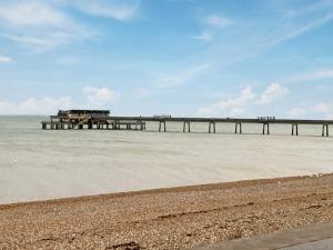 a pier on the beach next to a sandy beach at The Winchester in Deal